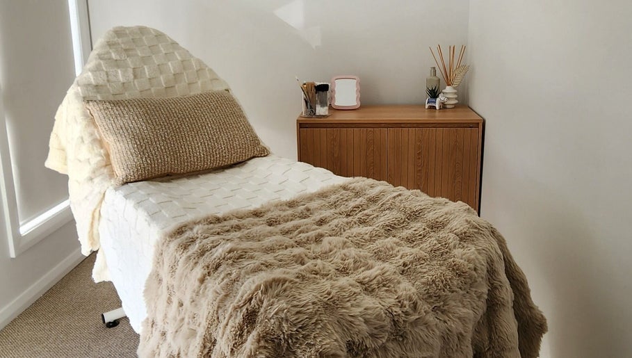 Cozy treatment room at Aurèla Beauty, Austral, New South Wales, AU, featuring a plush treatment bed.
