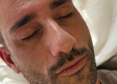 Close-up of a man relaxing after a facial treatment at Aurèla Beauty in Austral, New South Wales, AU.