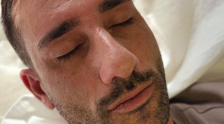 Close-up of a man relaxing after a facial treatment at Aurèla Beauty in Austral, New South Wales, AU.