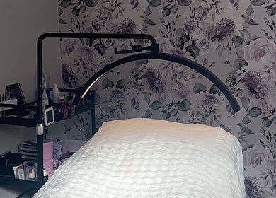 Cozy treatment room with floral wallpaper at Beauty By Yas, Attleborough, England, GB.