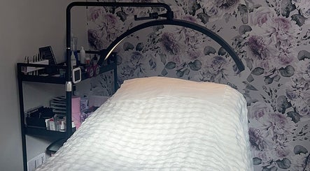 Beauty By Yas treatment room in Attleborough, England, GB, with floral wallpaper and cozy treatment bed.
