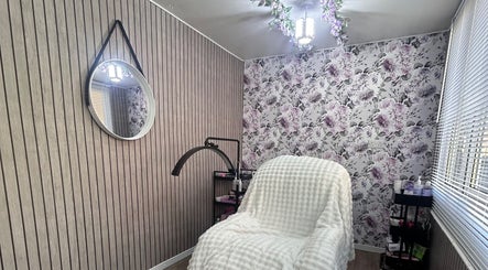 Cozy treatment room at Beauty By Yas, Attleborough, England, GB with floral wallpaper and modern decor.