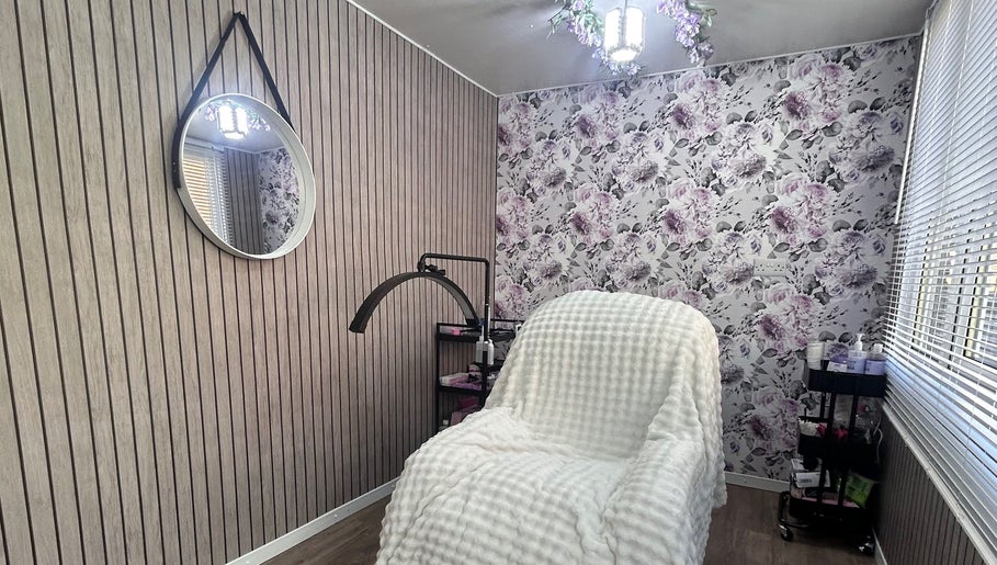 Cozy treatment room at Beauty By Yas in Attleborough, England, GB with floral wallpaper and elegant decor.