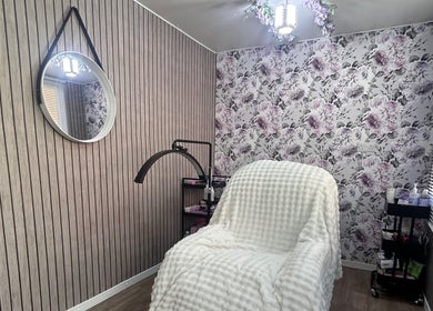 Cozy treatment room at Beauty By Yas in Attleborough, England, GB with floral wallpaper and elegant decor.