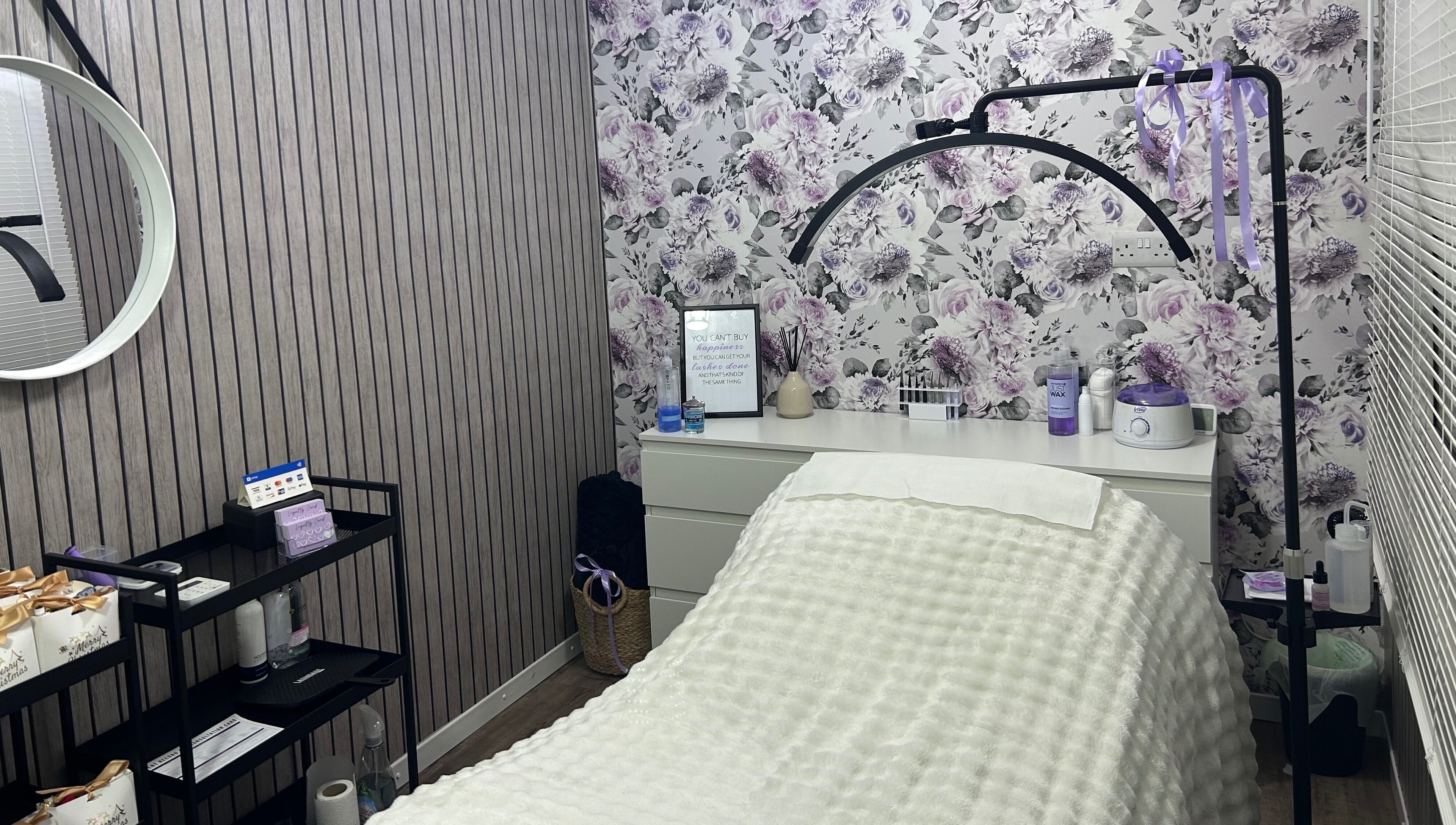 Relaxing treatment room at Beauty By Yas, Attleborough, England, GB with floral wallpaper and cozy decor.