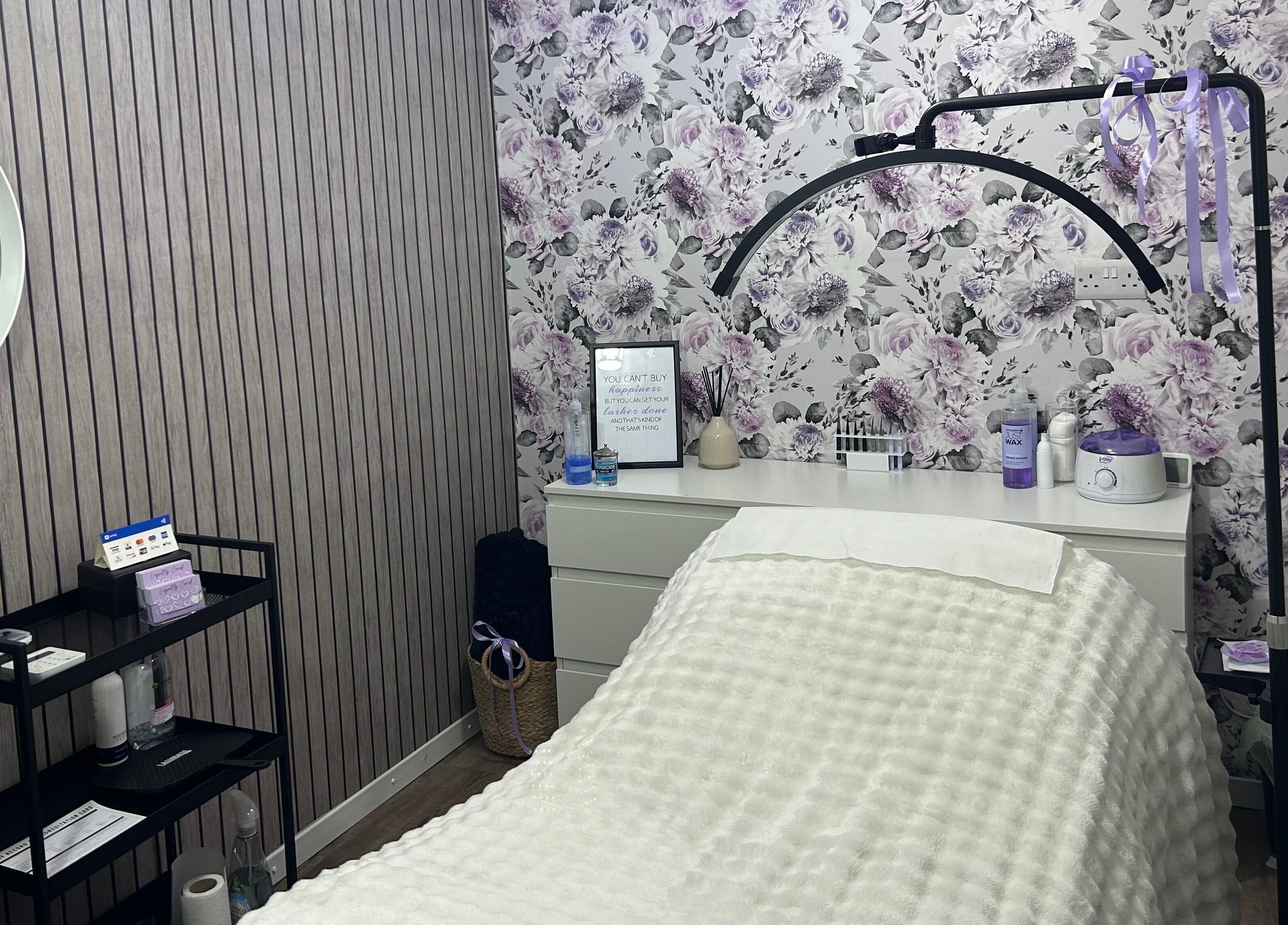Relaxing treatment room at Beauty By Yas, Attleborough, England, GB with floral wallpaper and cozy decor.