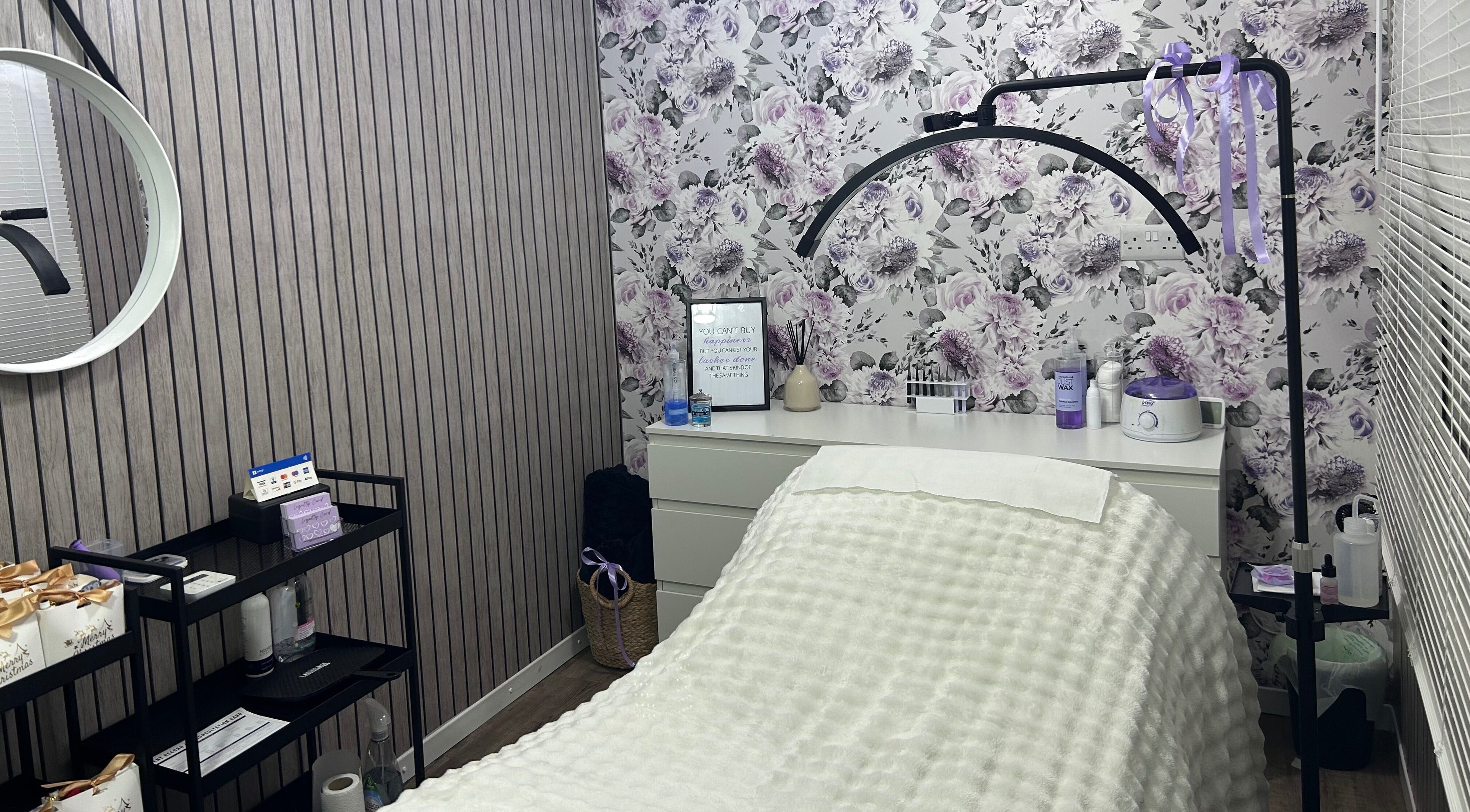 Relaxing treatment room at Beauty By Yas, Attleborough, England, GB with floral wallpaper and cozy decor.