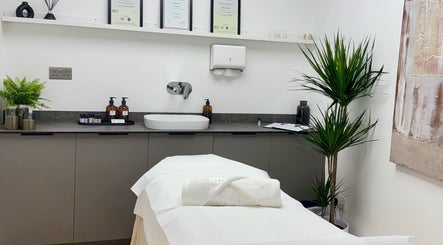Calming treatment room at Kenna Wellness & Spa, London, England, GB with plush bed and elegant decor.
