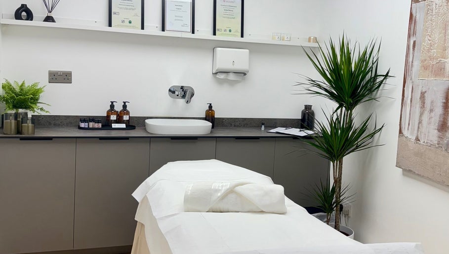 Relaxing treatment room at Kenna Wellness & Spa, London, England, GB with a massage table and soothing decor.