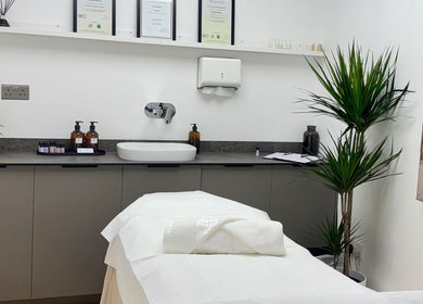 Relaxing treatment room at Kenna Wellness & Spa, London, England, GB with a massage table and soothing decor.