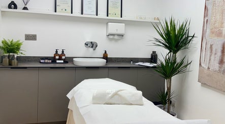 Tranquil treatment room at Kenna Wellness & Spa, London, England, GB with a pristine massage bed and elegant decor.