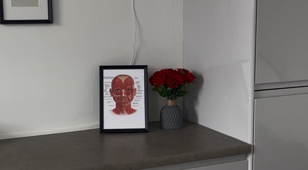 ByMara venue in Glasgow, Scotland, GB features a framed anatomical print and vase of red roses.