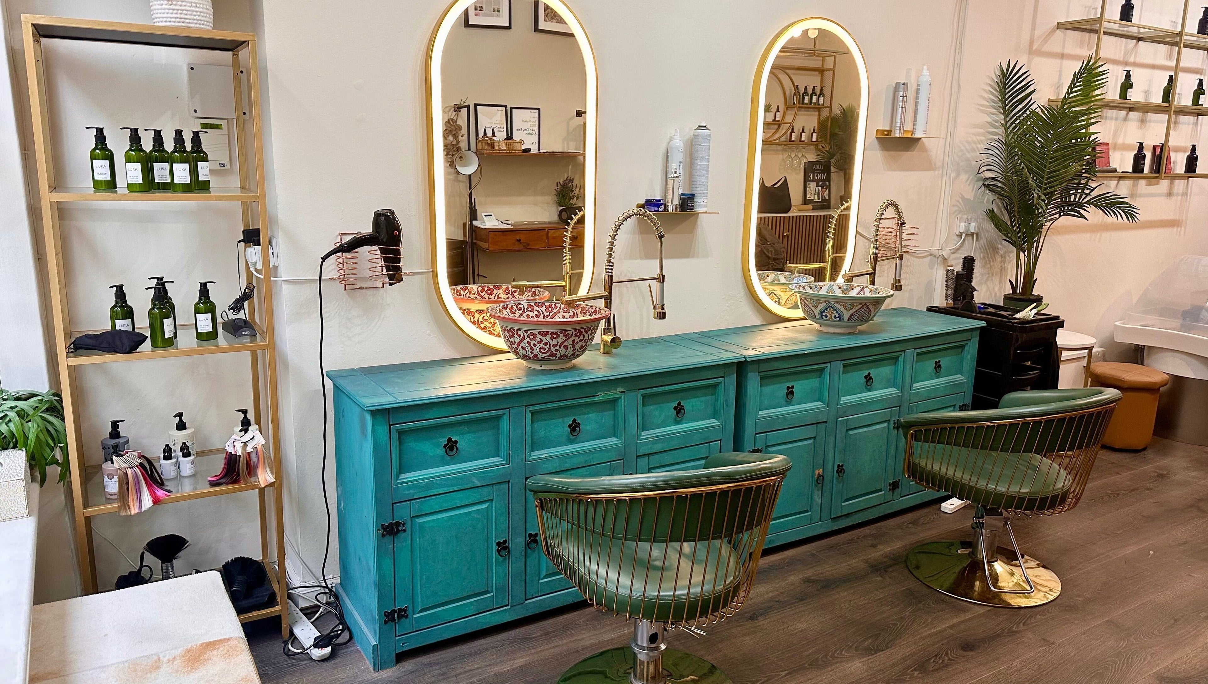 Chic styling area at Luka Day Spa Salon in London, England, GB with turquoise cabinets and ornate mirrors.