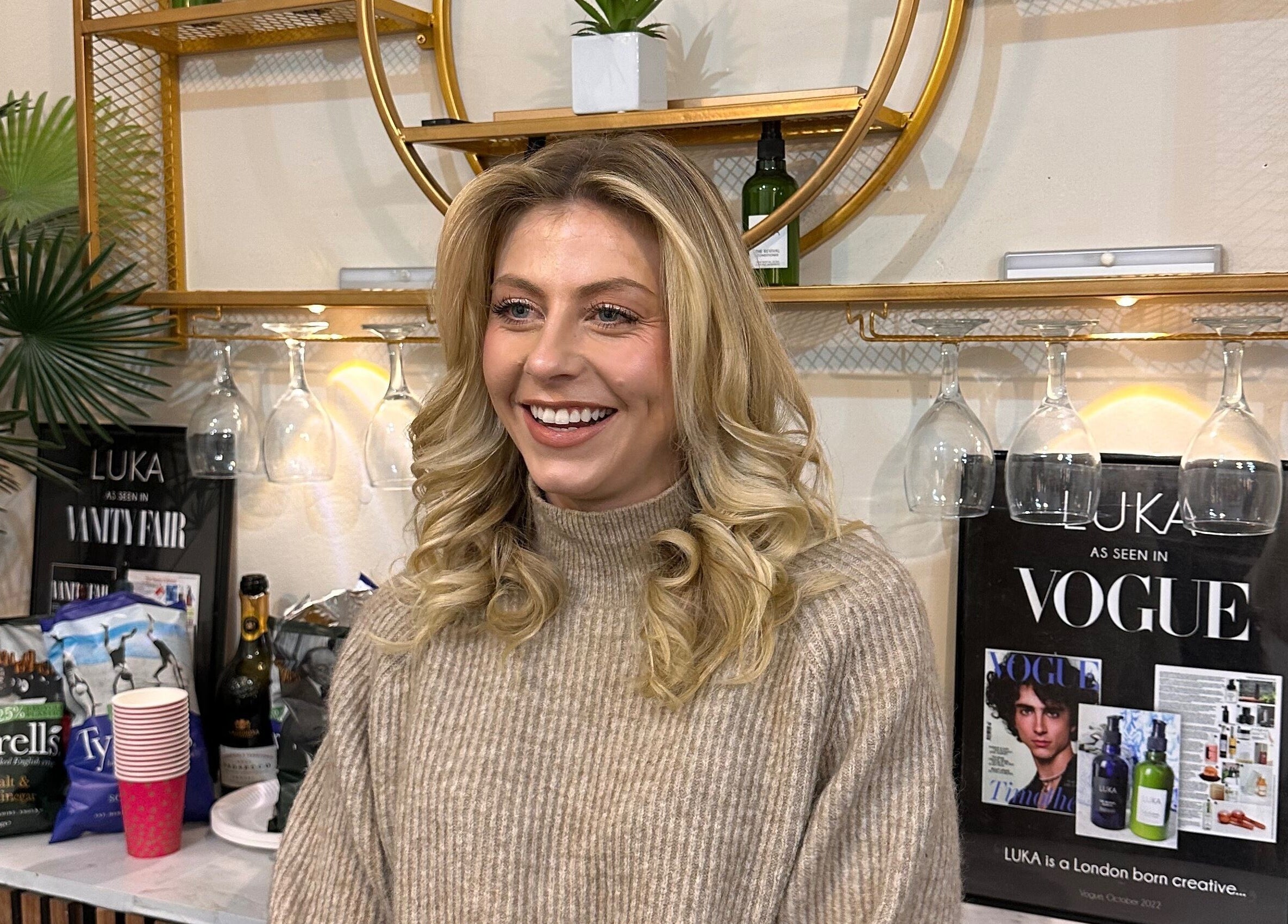 Smiling woman in stylish lounge at Luka Day Spa Salon, London, England, GB with chic decor.