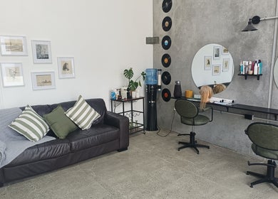 Ātahu Hair in Wellington, NZ features a stylish lounge and salon space with seating and art decor.