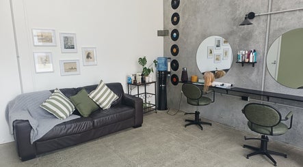 Ātahu Hair in Wellington, NZ features a stylish lounge and salon space with seating and art decor.