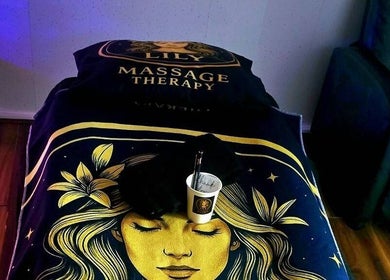 Massage table at Lily Massage Therapy, Glasgow, Scotland, GB, with calming decor.