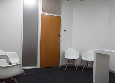 Relaxing waiting area at Balancing Wellness, Melbourne, Victoria, AU with modern white chairs and a minimalist design.