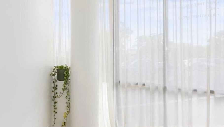 Bright, serene corner at Haus of Contouring - Shellharbour Clinic, with white curtains in Shellharbour City Centre.