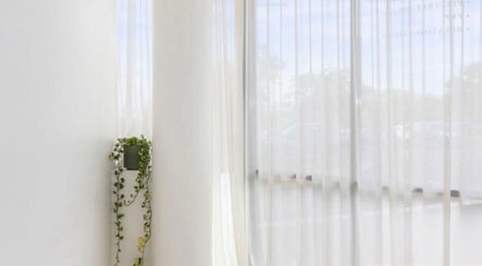 Bright, serene corner at Haus of Contouring - Shellharbour Clinic, with white curtains in Shellharbour City Centre.