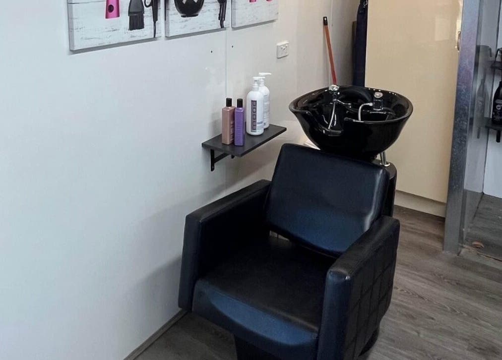 Modern wash station at Shac Studio, Forbes, New South Wales, AU, featuring sleek chair and hair products.