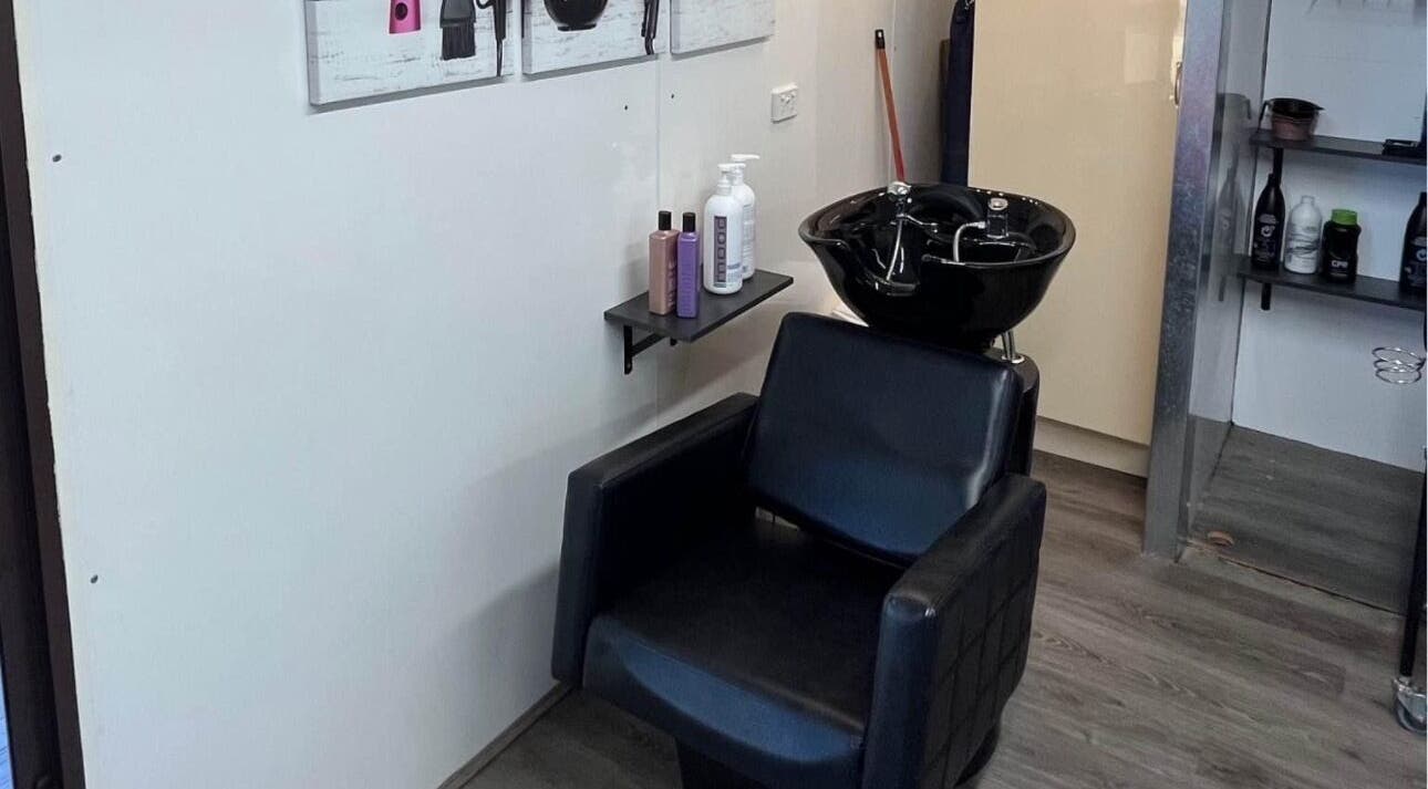 Modern wash station at Shac Studio, Forbes, New South Wales, AU, featuring sleek chair and hair products.