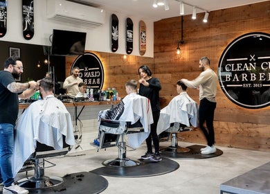 Stylish barbers giving haircuts at Clean Cut Barbers, Caringbah South, New South Wales, AU.