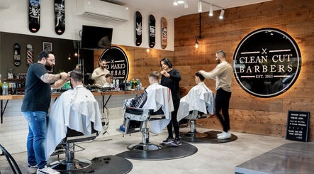 Stylish barbers giving haircuts at Clean Cut Barbers, Caringbah South, New South Wales, AU.