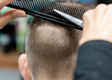 Expert haircut at Clean Cut Barbers, Caringbah South, New South Wales, AU. Hair being precisely trimmed.