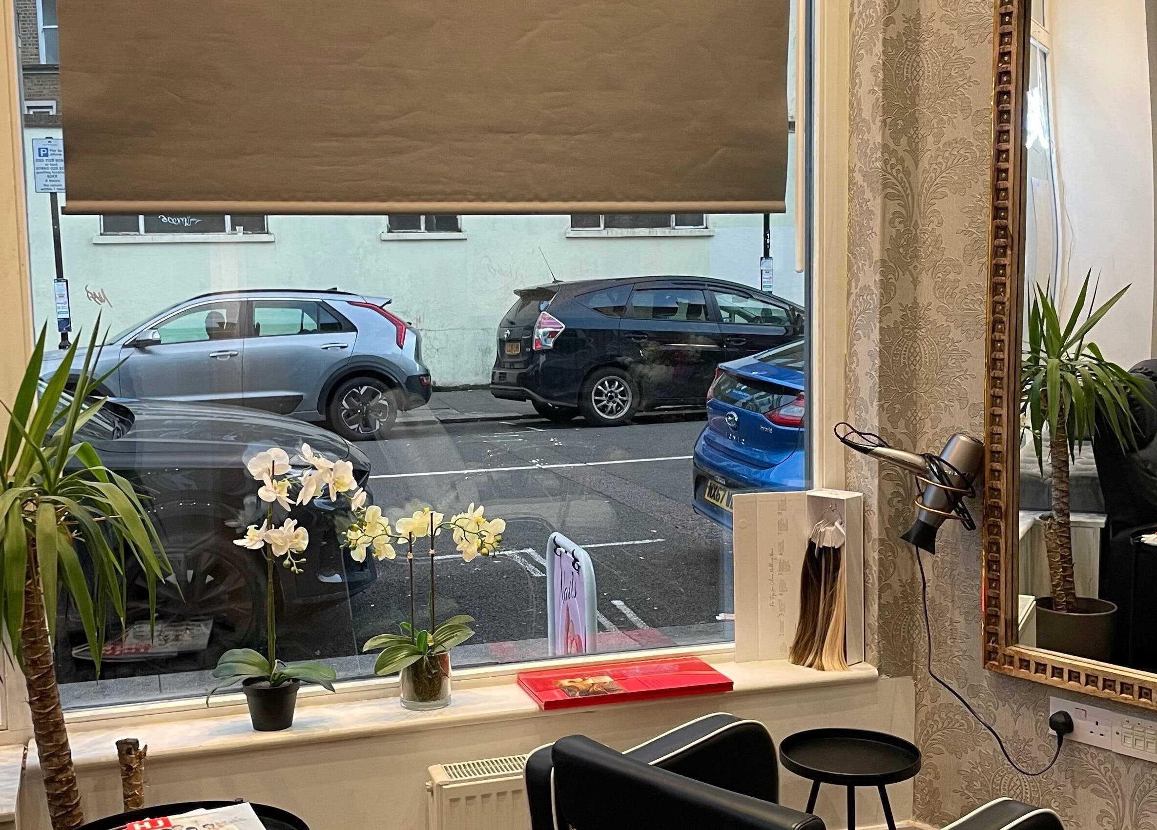Interior of Sophie Michelle Hair in London, England, GB with stylish decor and a large window view.