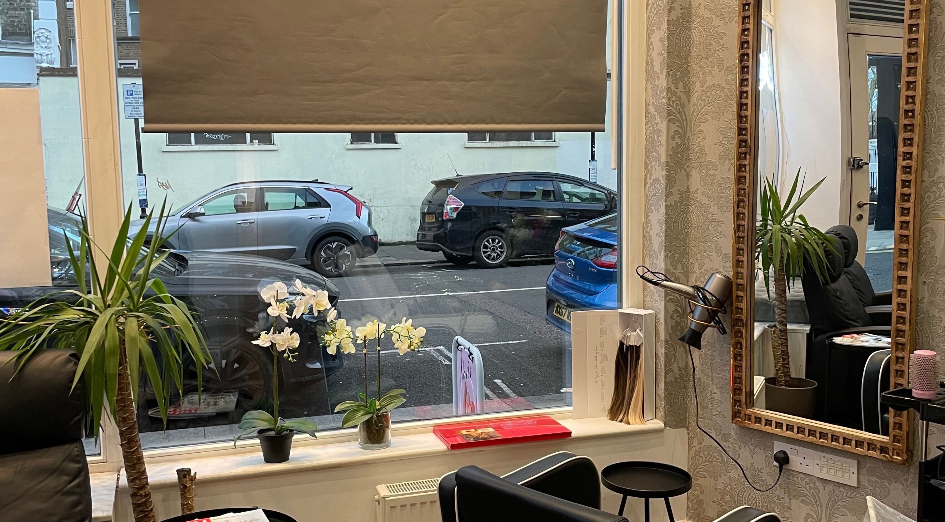 Interior of Sophie Michelle Hair in London, England, GB with stylish decor and a large window view.