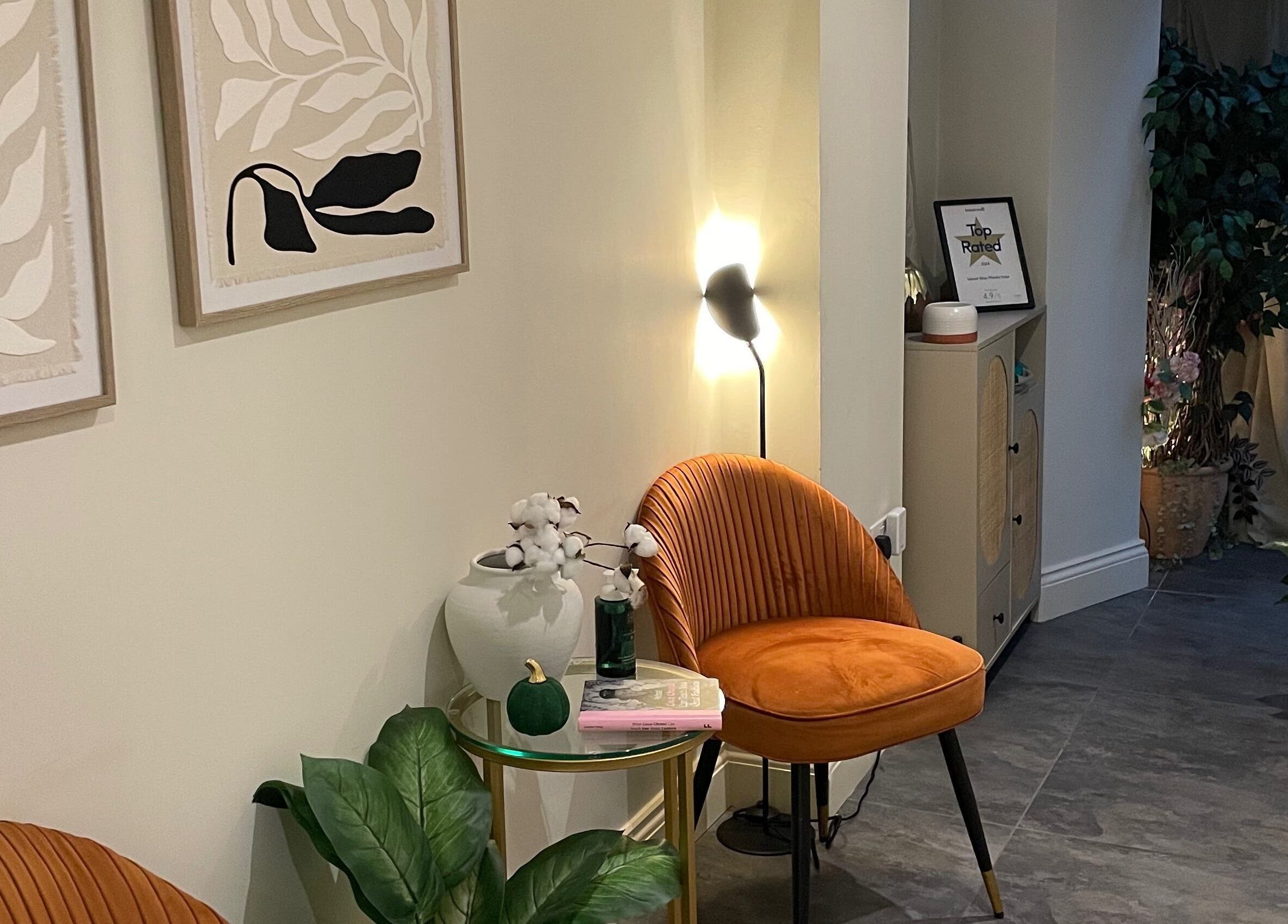 Cozy waiting area at Sophie Michelle Hair, London, England, GB with modern art and plush seating.