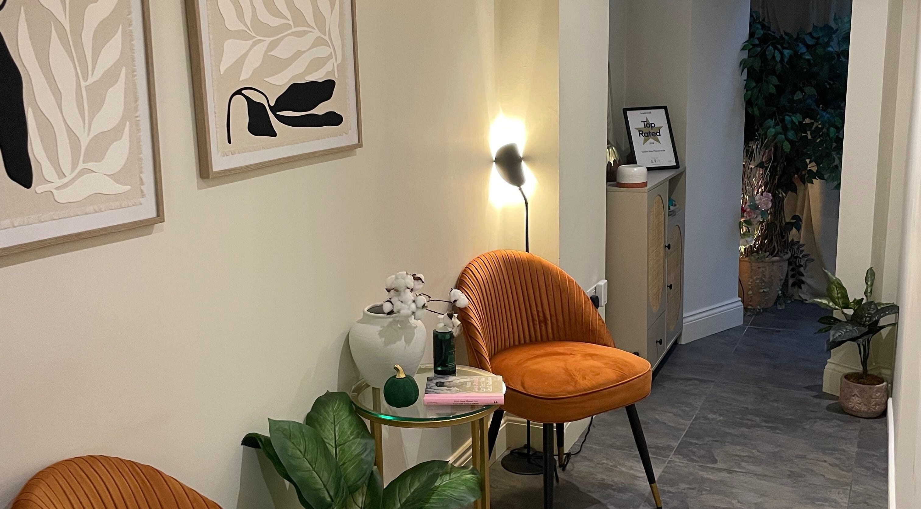 Cozy waiting area at Sophie Michelle Hair, London, England, GB with modern art and plush seating.