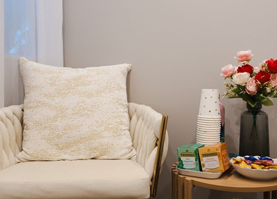 Cozy sitting area at GORGEOUS LASHES BY THUY, West End, Queensland, AU, with a plush chair and floral decor.