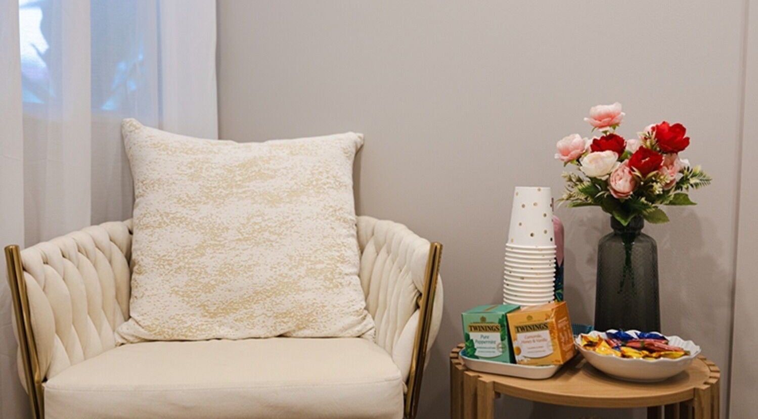 Cozy sitting area at GORGEOUS LASHES BY THUY, West End, Queensland, AU, with a plush chair and floral decor.