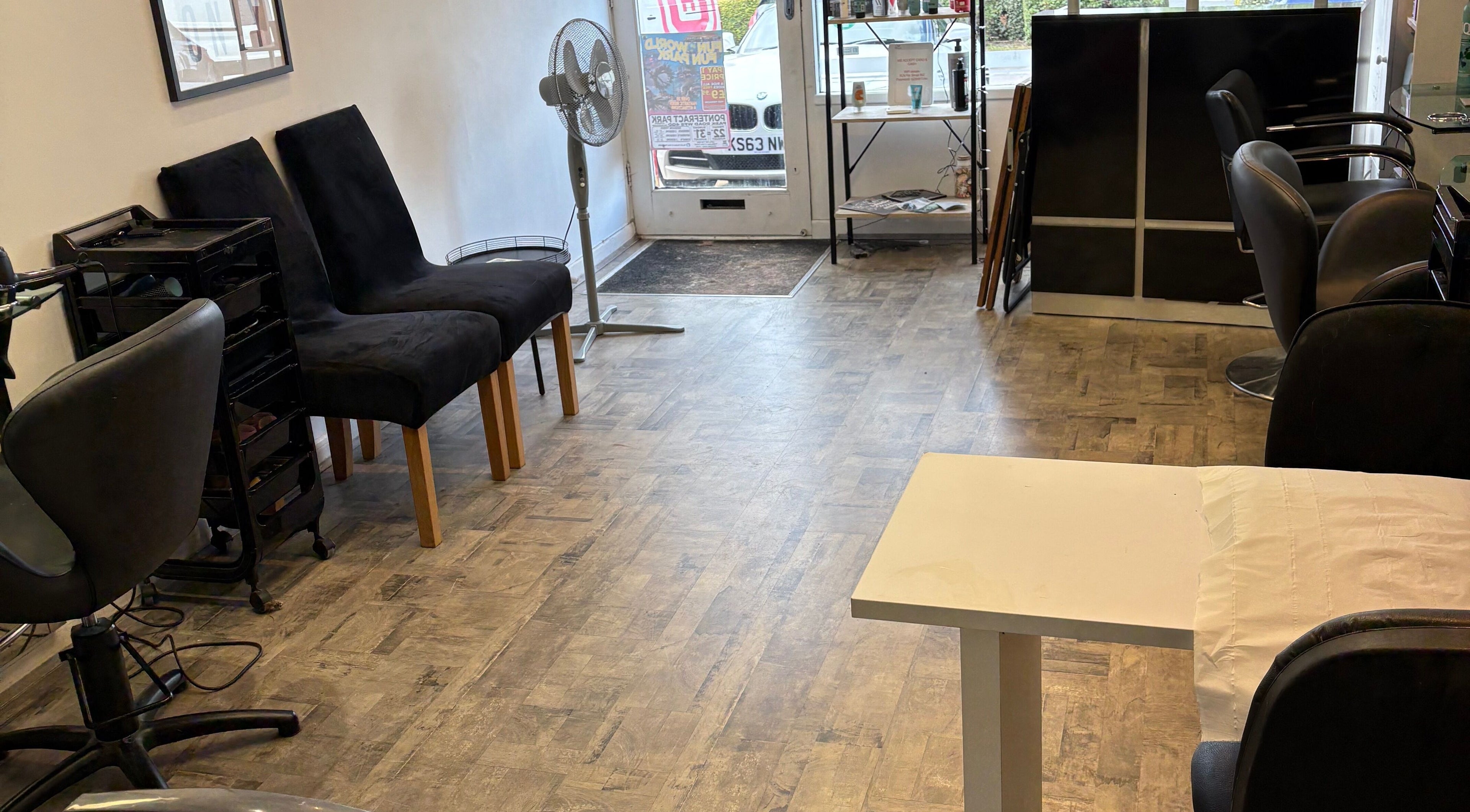 Welcoming interior of Mirrors Hair & Beauty in Castleford, England with elegant seating and styling stations.