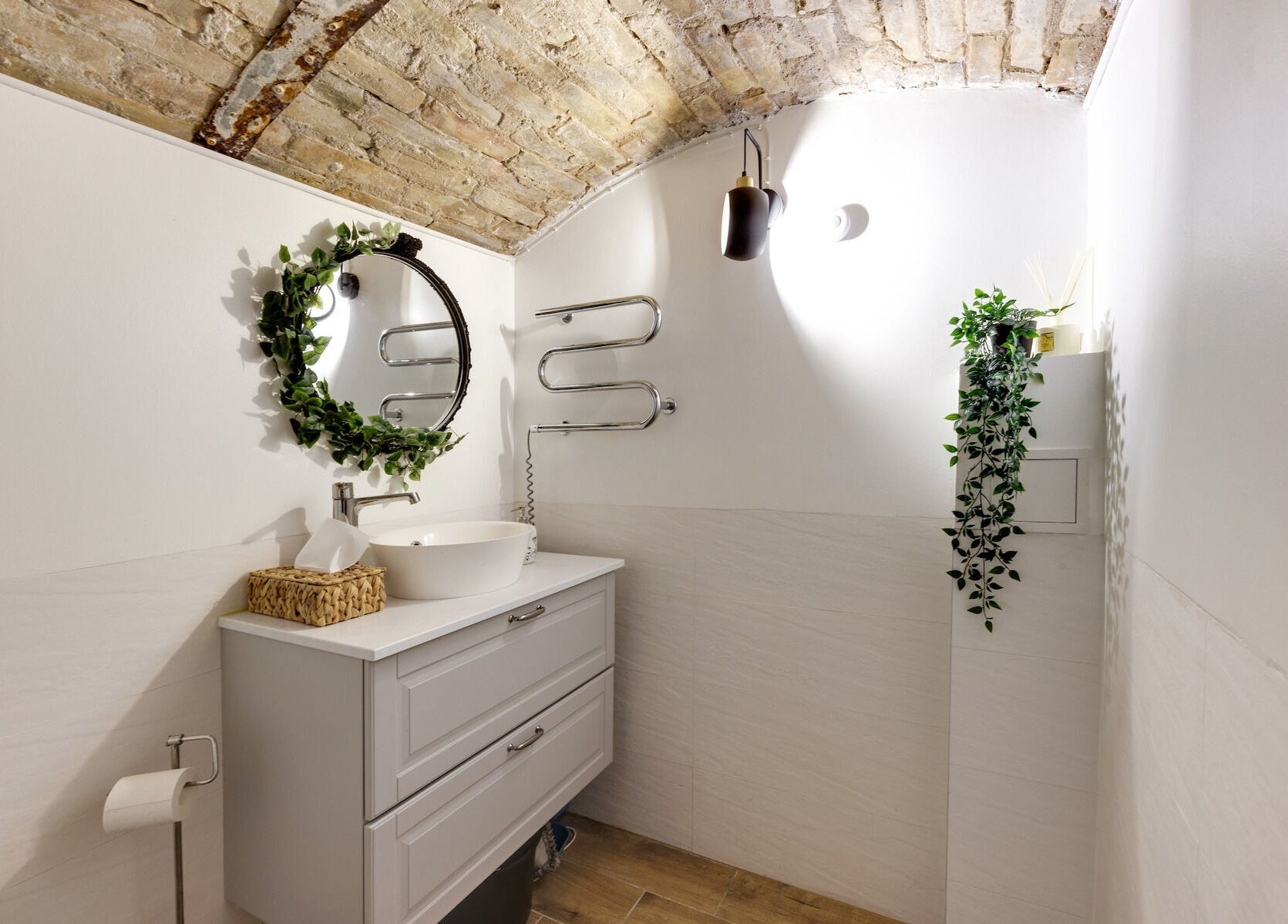 Stylish bathroom at My Lamination Studija, Vilnius, Vilniaus Apskritis, LT featuring rustic decor and lush greenery.