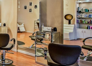 Chic interior of Elaris Beauty Salon in Dubai, AE. Modern styling stations and product display.