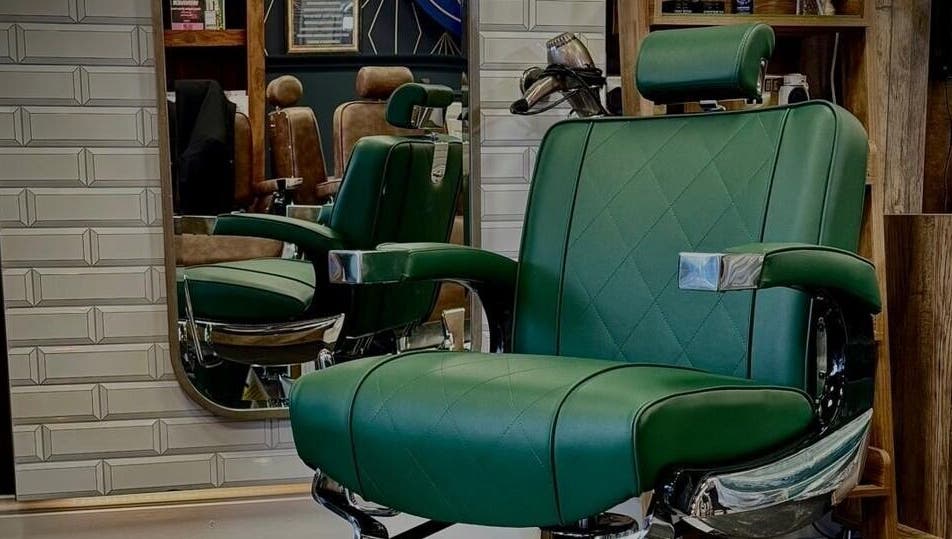 Green barber chair at Webster & Carr, Newcastle upon Tyne, England, GB.
