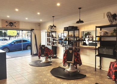 Spacious interior of The Barberworks in Marrickville, New South Wales, AU with modern barber chairs and decor.