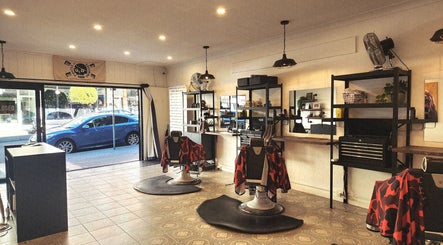 Spacious interior of The Barberworks in Marrickville, New South Wales, AU with modern barber chairs and decor.