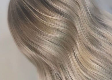 Elegant blonde hair styled at Aurore&Ember, Ryton, England, GB, showcasing smooth, sleek waves.