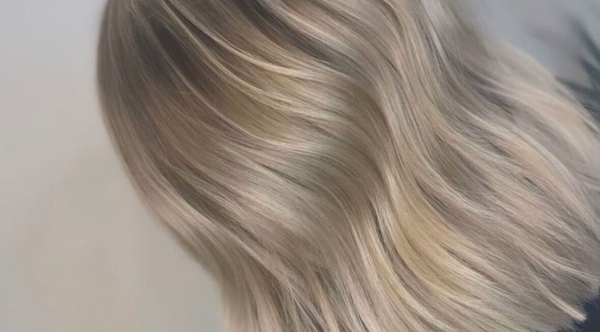 Elegant blonde hair styled at Aurore&Ember, Ryton, England, GB, showcasing smooth, sleek waves.