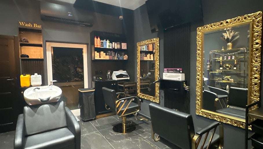 Elegant salon interior at Vogue & Volume, Il-ħamrun, MT, featuring gold mirrors and chic styling chairs.