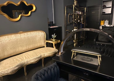 Elegant gold-accented interior at Vogue & Volume, Il-ħamrun, MT showcasing luxurious seating and decor.