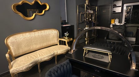 Elegant gold-accented interior at Vogue & Volume, Il-ħamrun, MT showcasing luxurious seating and decor.