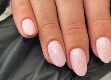 Close-up of glittery soft pink nails at The Nail Babe in Bromley, England, GB.