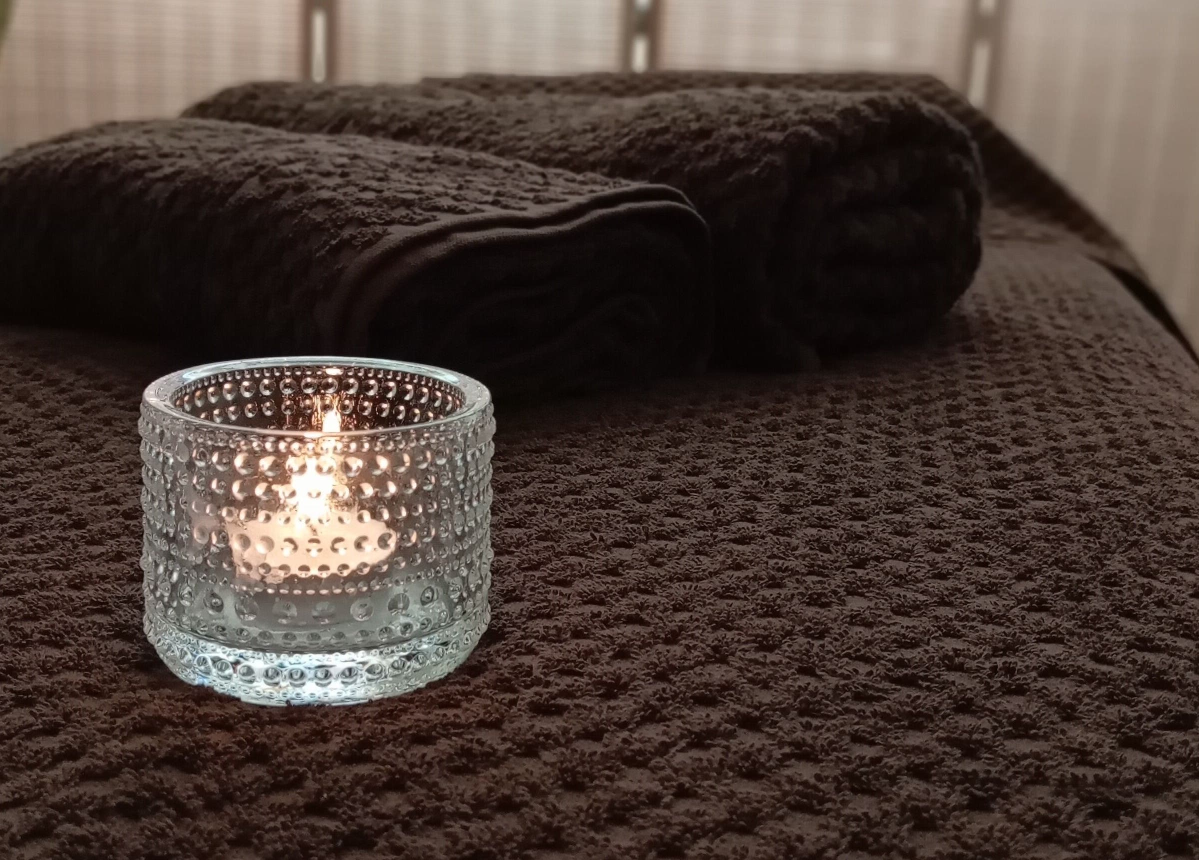 Cozy candle-lit massage table at Melt Massage in Royal Leamington Spa, England, GB.