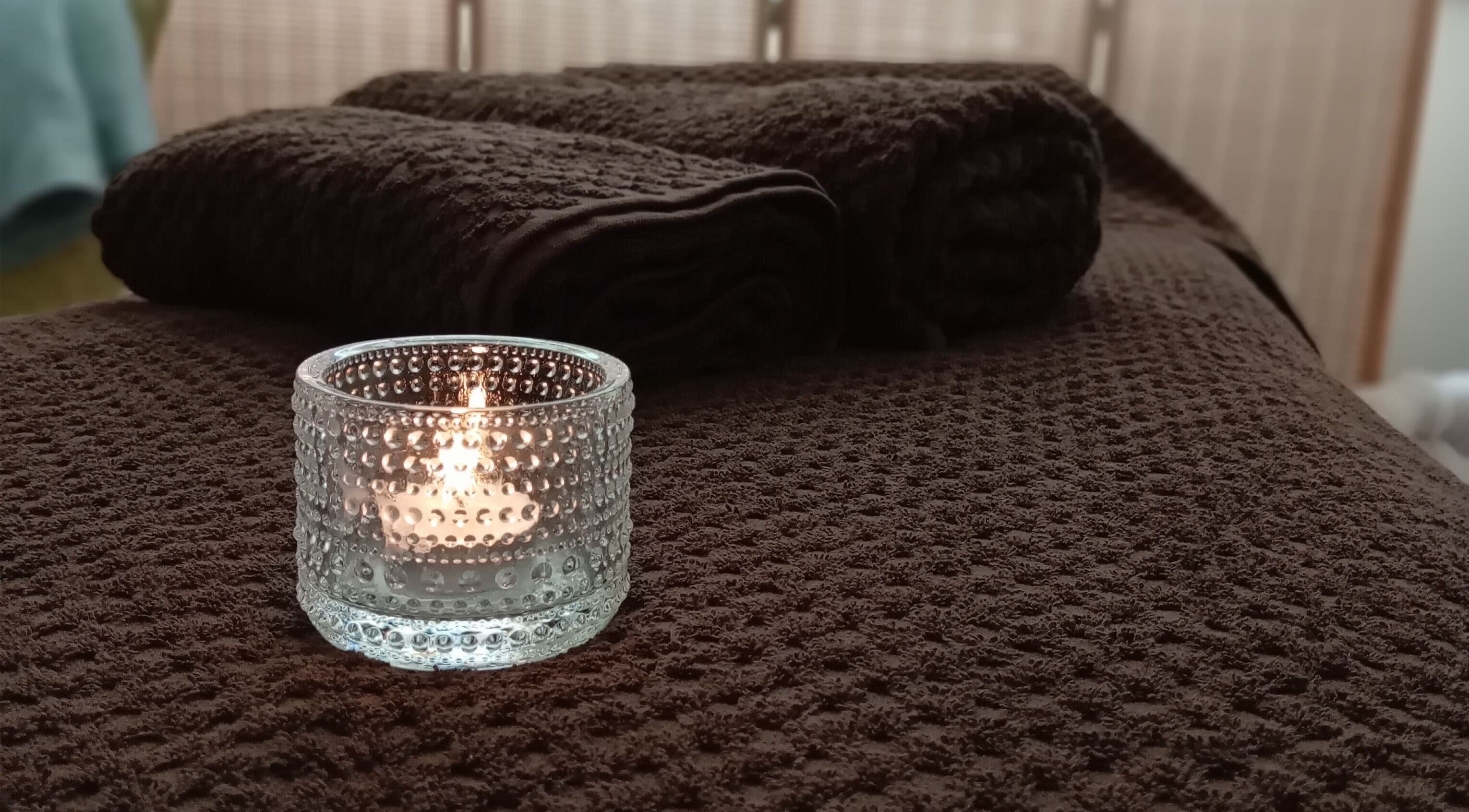 Cozy candle-lit massage table at Melt Massage in Royal Leamington Spa, England, GB.