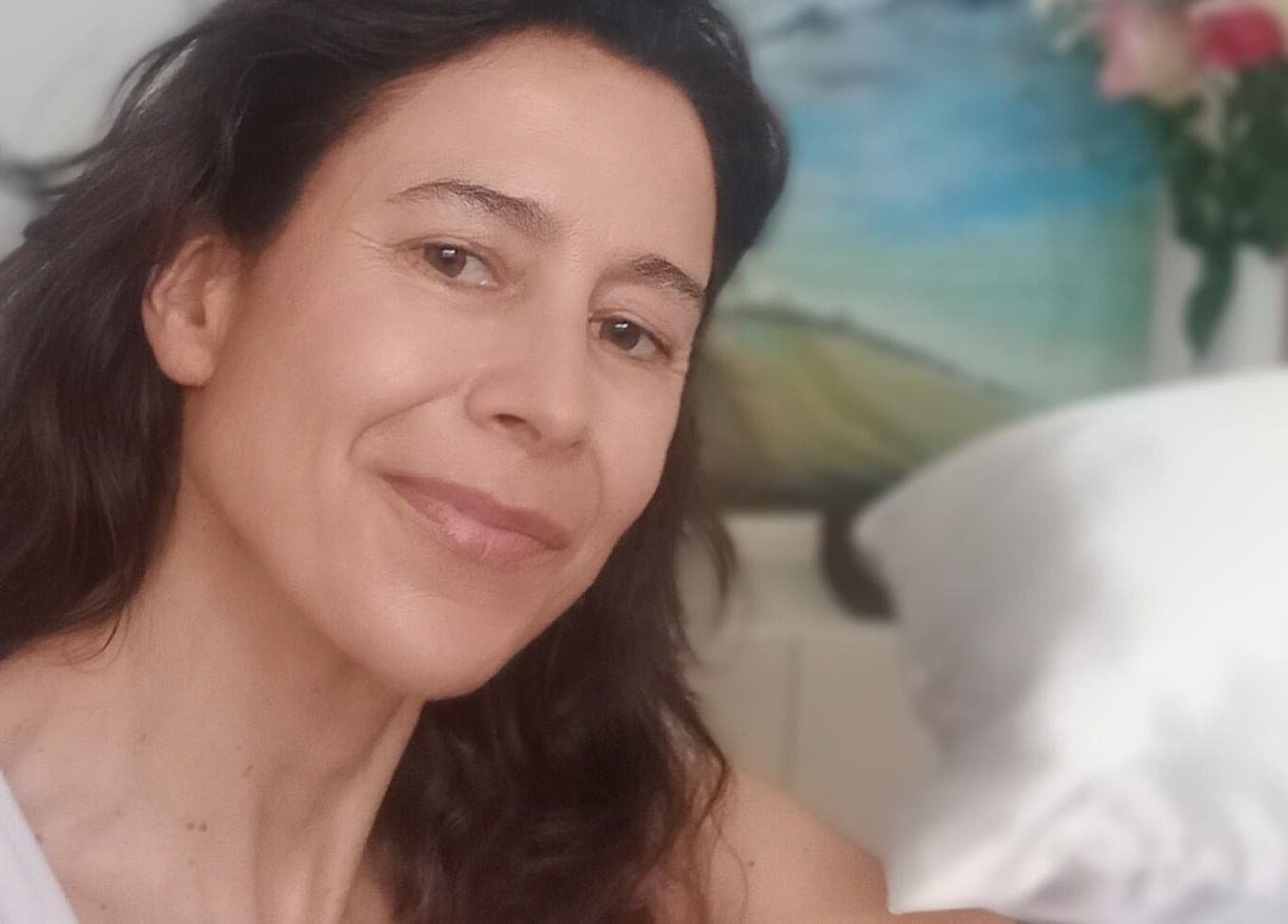 Relaxed woman smiling at Melt Massage, Royal Leamington Spa, England, GB with cozy ambiance.